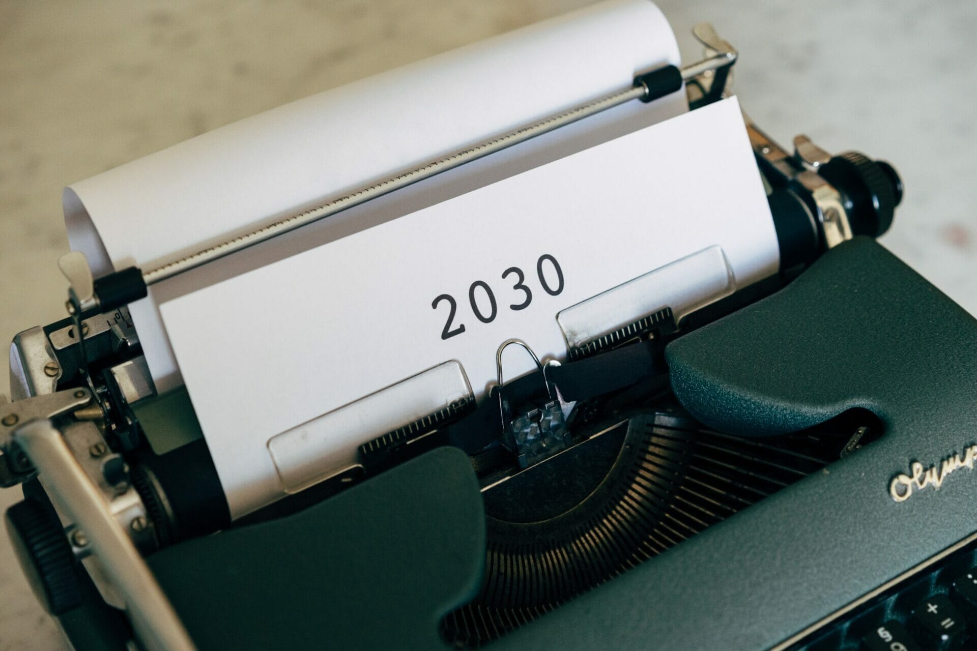 Typewriter with paper showing the text "2030"