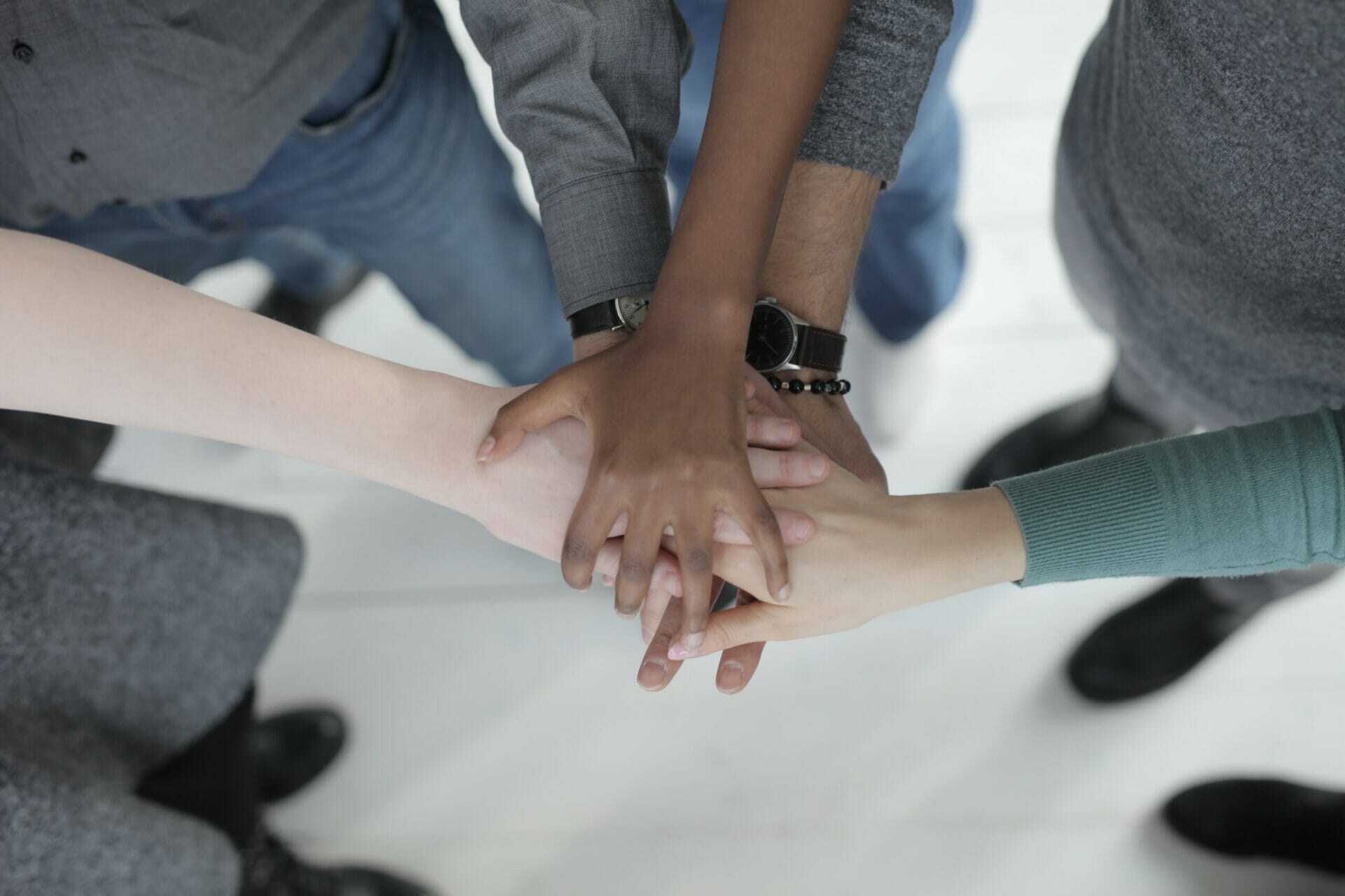 Group of colleagues holding hands in circle
